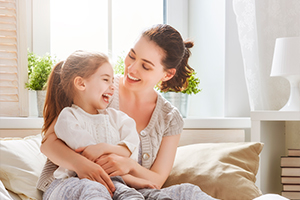 Woman and her daughter laughing