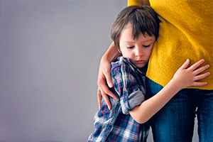 Kid hugging his mother