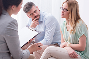 Couple discussing with an attorney