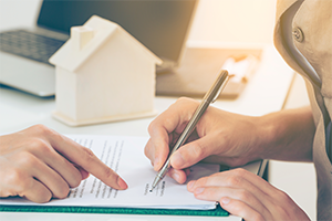 Woman signing Property Ownership contract