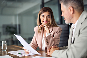 An attorney and her client smiling